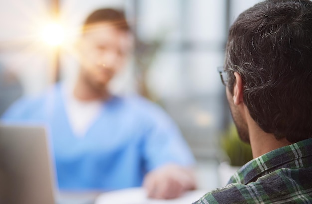 Doctor with patient in medical office at the reception