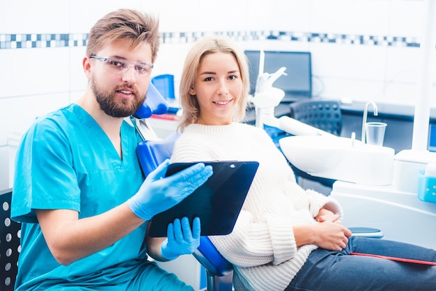 Doctor with patient reading notes form notepad