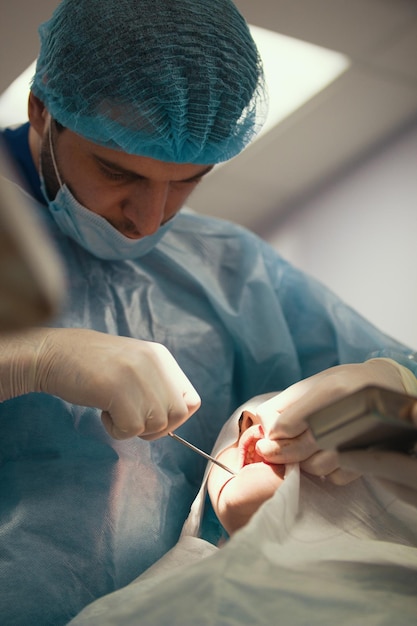 Photo doctor with patient in stomatology room, close up