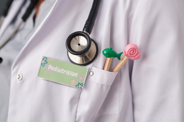 Doctor with pediatrician id badge on lab coat