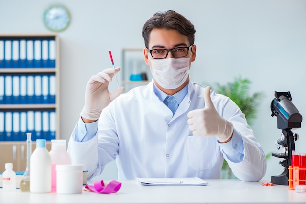 Photo doctor with red blood sample