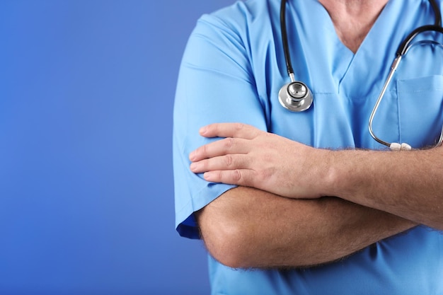 Doctor with stethoscope on colorful background