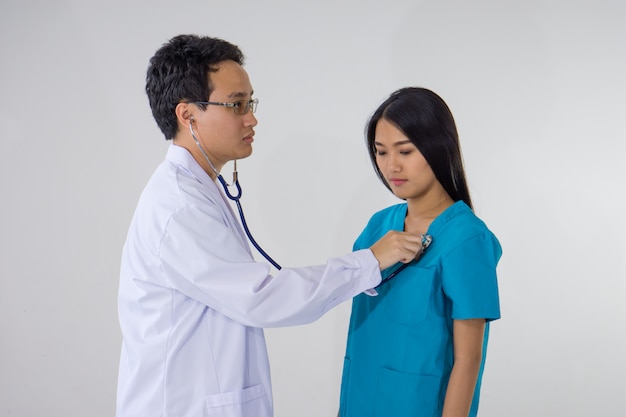 Doctor with stethoscope examining heart