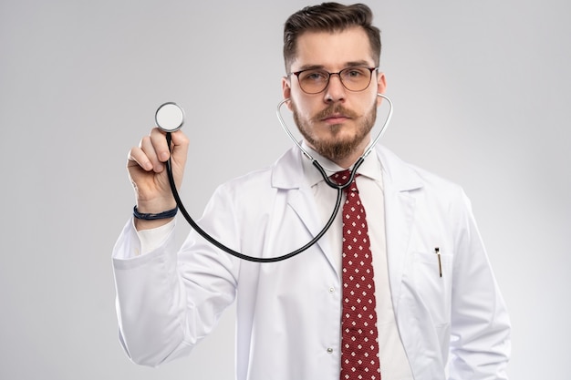 Doctor with a stethoscope in the hand, medical care concept