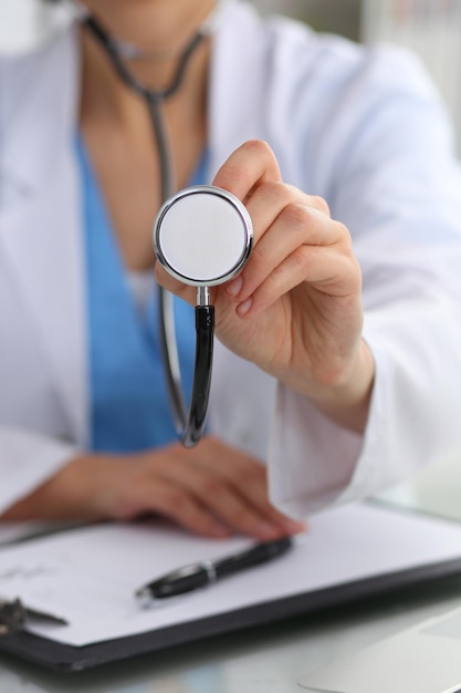 Doctor with a stethoscope in the hands, close up. Physician ready to examine and help patient. Medicine, healthcare and help concept.