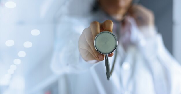 Doctor with a stethoscope in the hands on hospital background