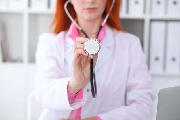 Doctor with a stethoscope in the hands. Pink colored scene