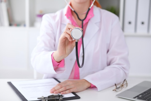 Doctor with a stethoscope in the hands. Pink colored scene