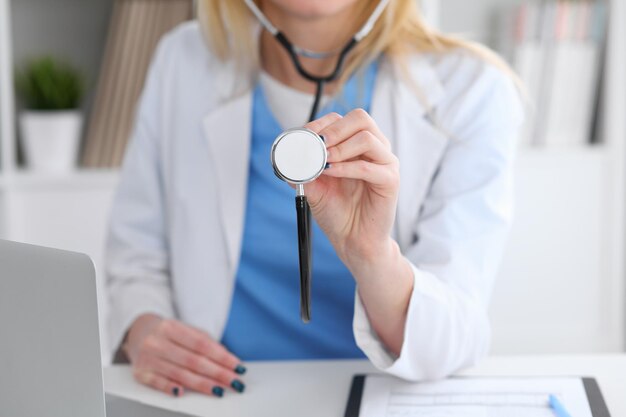 Doctor with a stethoscope in the hands ready to exemine patient