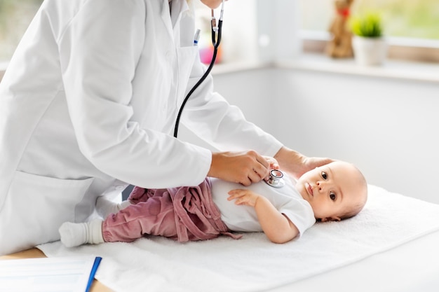doctor with stethoscope listening to baby patient