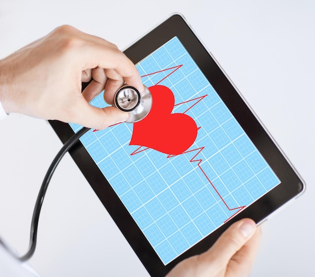 doctor with stethoscope listening heart beat on tablet pc