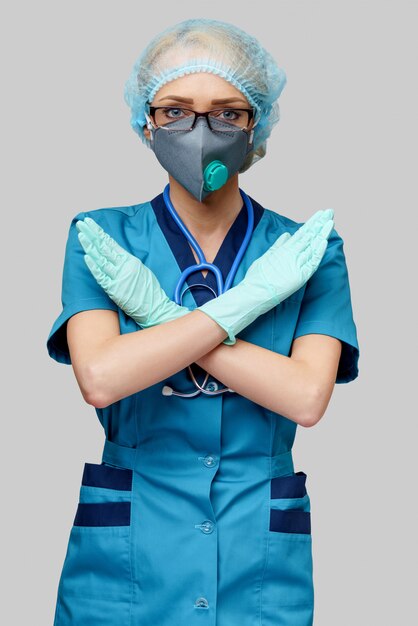 Doctor with stethoscope wearing protective mask and latex gloves