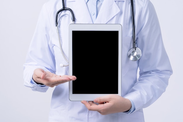 Doctor with a stethoscope in a white coat holding tablet