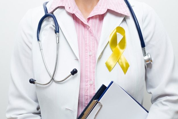 Doctor with a symbolic yellow ribbon on his chest.