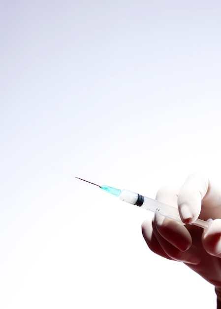 Doctor with syringe for coronavirus vaccine injection.