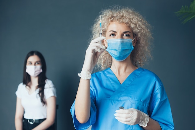 Photo doctor with syringe in hand and a patient near young girl getting vaccinated vaccination concept