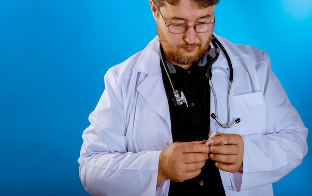 Doctor with a syringe in his hand and in a suit