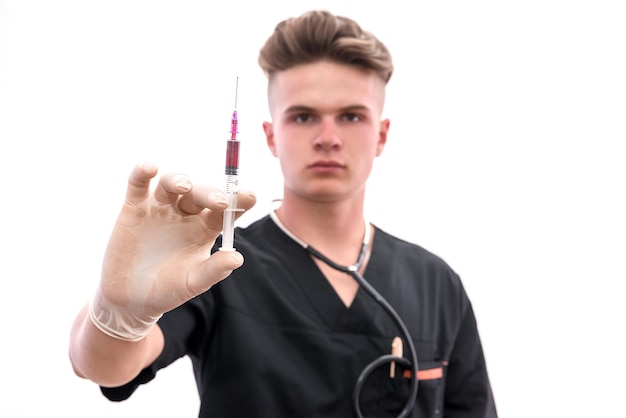 Doctor with syringe. Young doctor in medic uniform holding syringe in hand with glove isolated on white