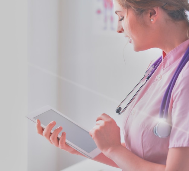 Doctor woman checking medical data on tablet pc