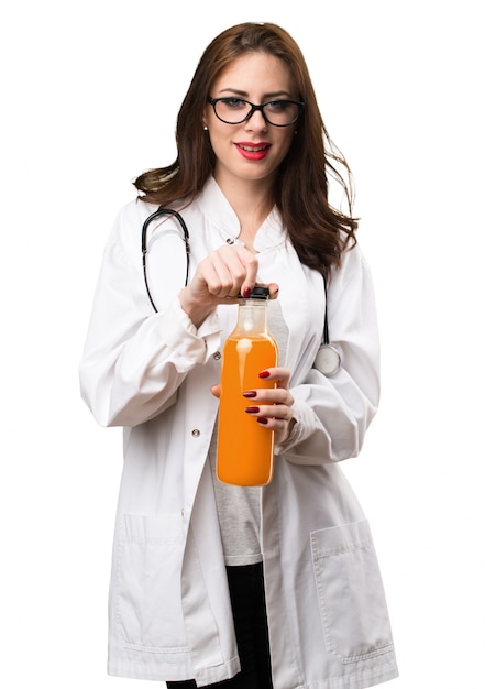 Doctor woman holding a orange juice