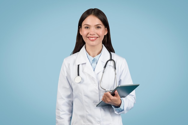 Doctor woman holding tablet with welcoming smile