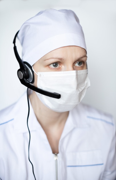 Doctor woman wearing protective mask in headset.