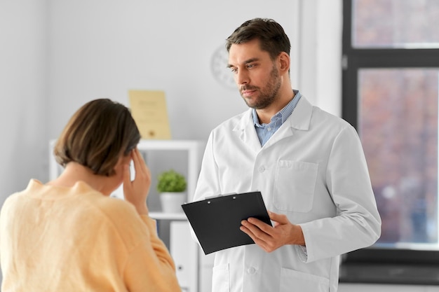 doctor and woman with health problem at hospital