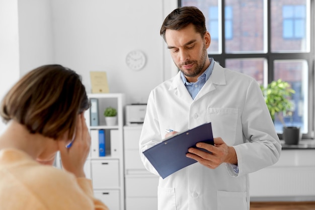 doctor and woman with health problem at hospital