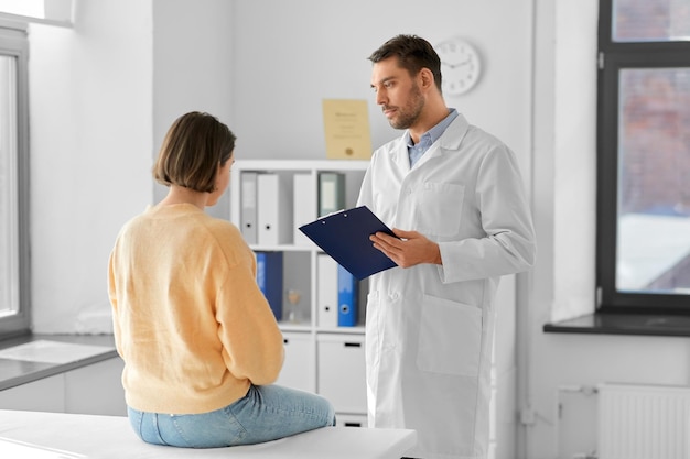 doctor and woman with health problem at hospital