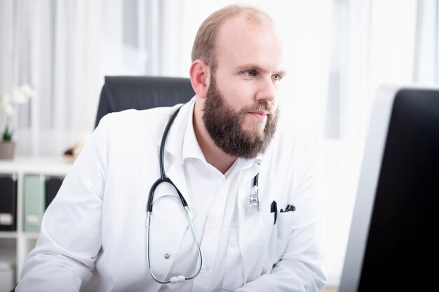 Doctor working on computer in hospital