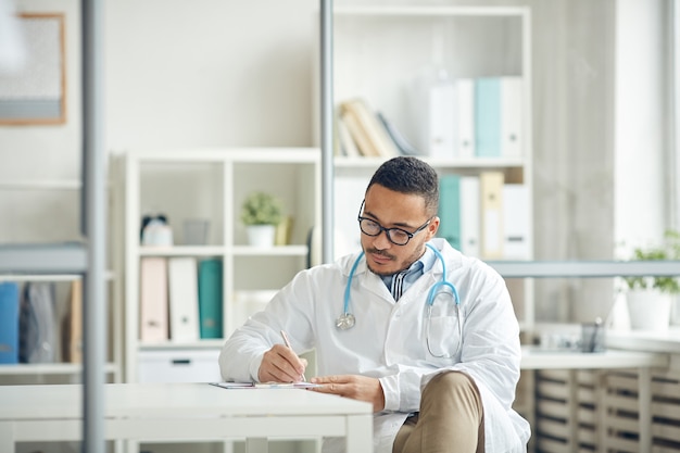 Doctor Working at Desk in Office