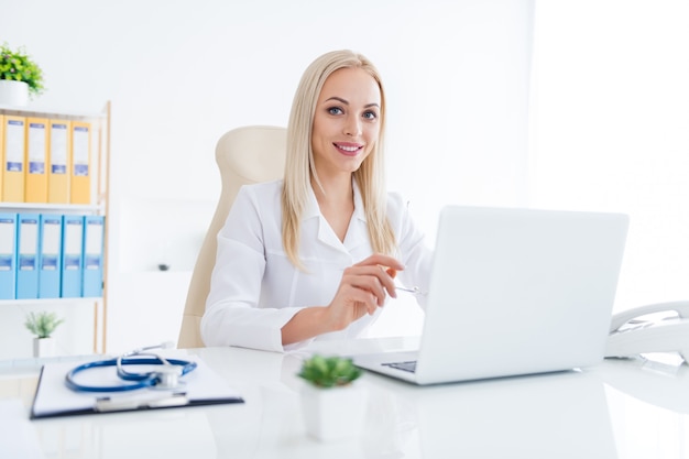 doctor working on laptop in her office