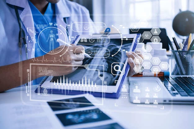 Doctor working on the table examine the concept of finding information and documents in hospital room