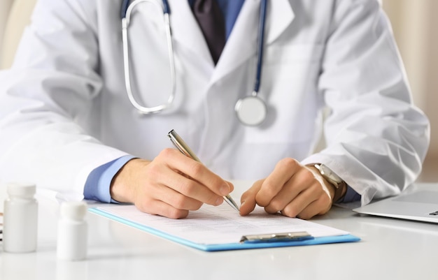 Doctor working at table in office