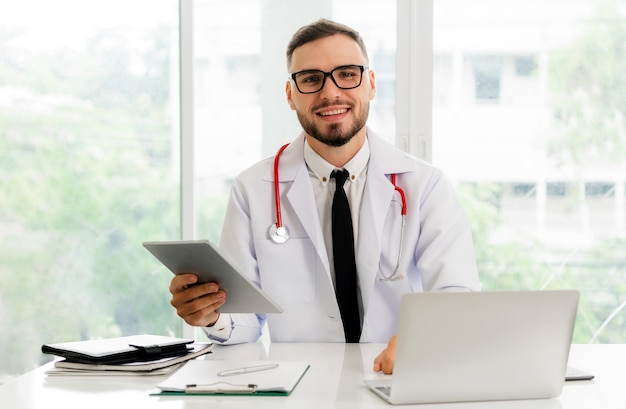 Doctor working on tablet computer in the hospital.