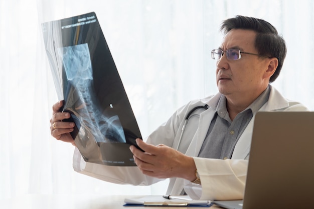 Doctor working with patient health data in the hospital office.