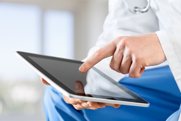 Doctor working with tablet pc, partial view