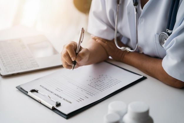 Doctor working to write a patient report in the clinic