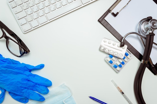 Doctor workplace with a stethoscope on white background