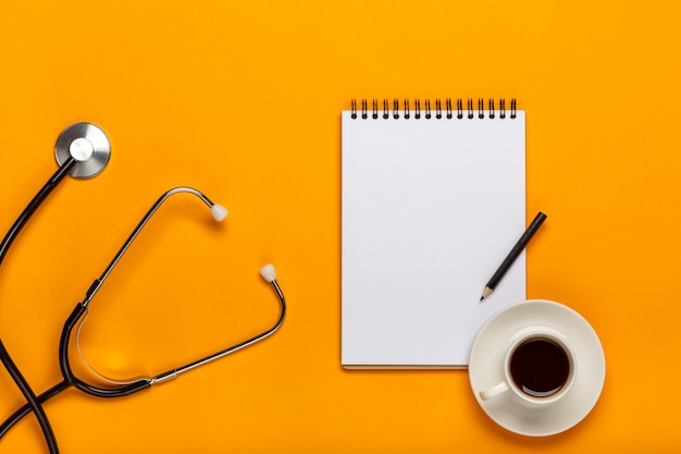 Doctor workspace with Medical equipment on yellow table with top view