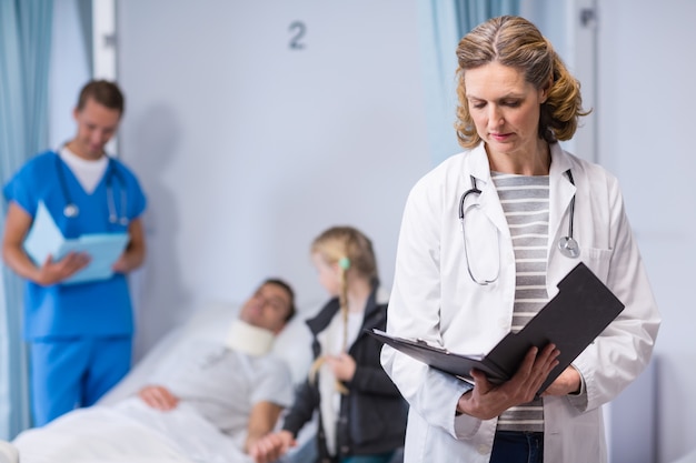 Doctor writing on clipboard