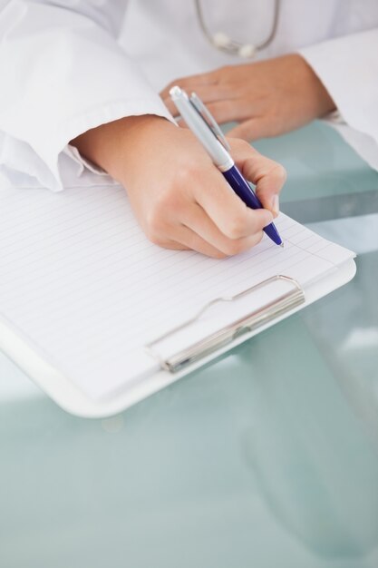 Photo doctor writing down work notes