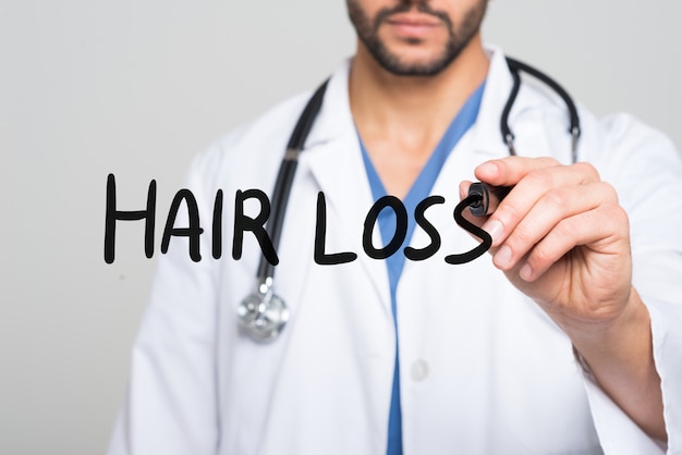 Doctor writing Hair Loss