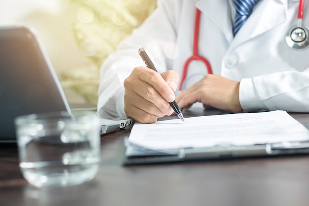 doctor writing information to patient 