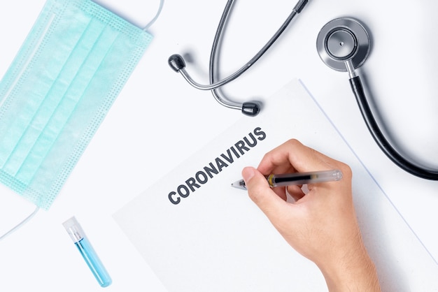 Doctor writing prevention on Coronavirus file on the table