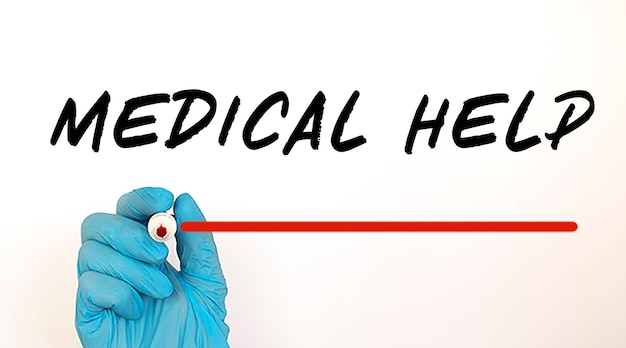 Doctor writing text MEDICAL HELP with red marker. Medical concept.