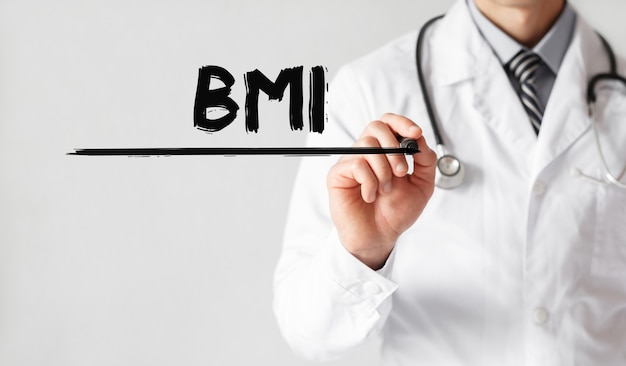 Doctor writing word BMI with marker