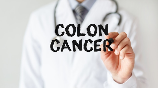 Doctor writing word Colon Cancer with marker