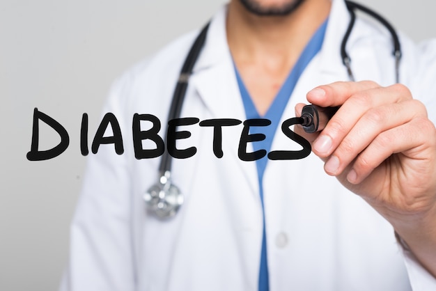 Doctor writing the word Diabetes