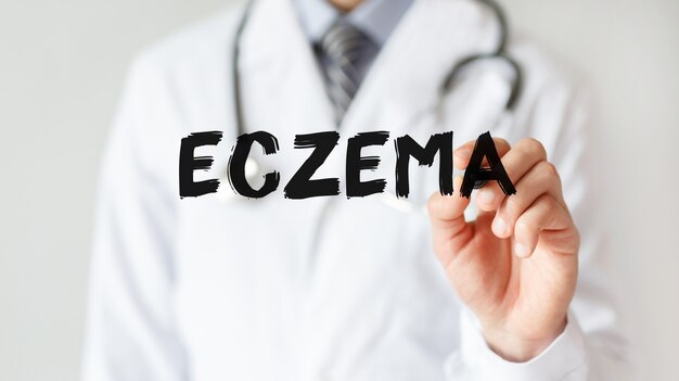 Doctor writing word ECZEMA with marker